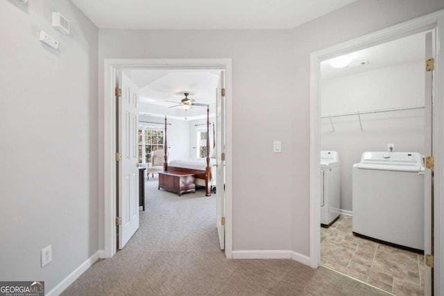 laundry room with baseboards, laundry area, independent washer and dryer, and light colored carpet