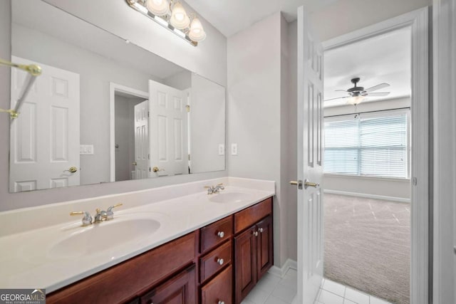 bathroom featuring double vanity, baseboards, a ceiling fan, and a sink