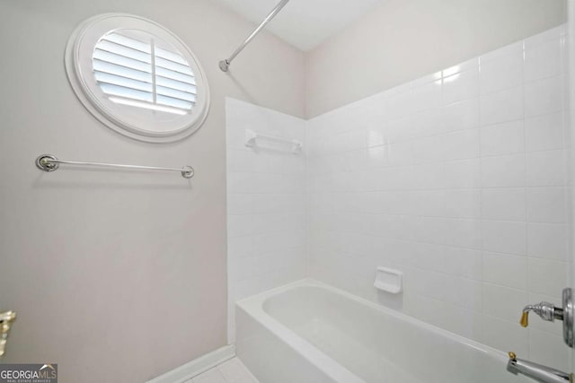 full bath featuring washtub / shower combination and baseboards