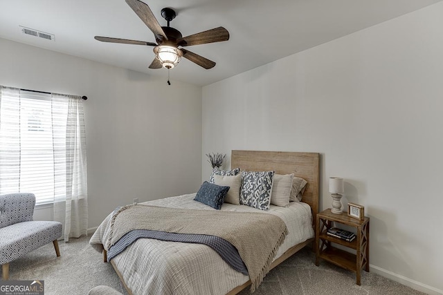 carpeted bedroom featuring baseboards, visible vents, and ceiling fan