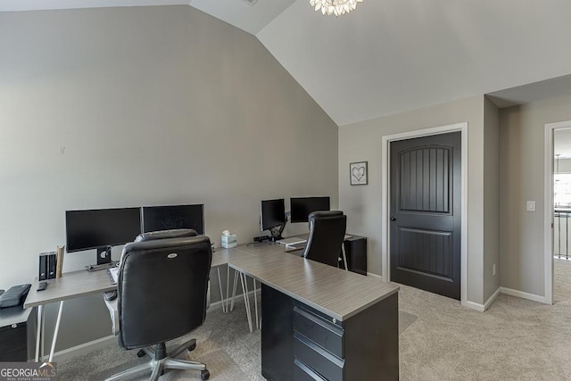 office space with baseboards, high vaulted ceiling, and light colored carpet