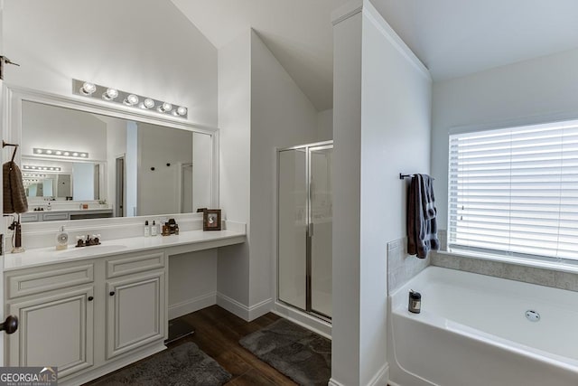 full bathroom with lofted ceiling, a garden tub, wood finished floors, vanity, and a stall shower