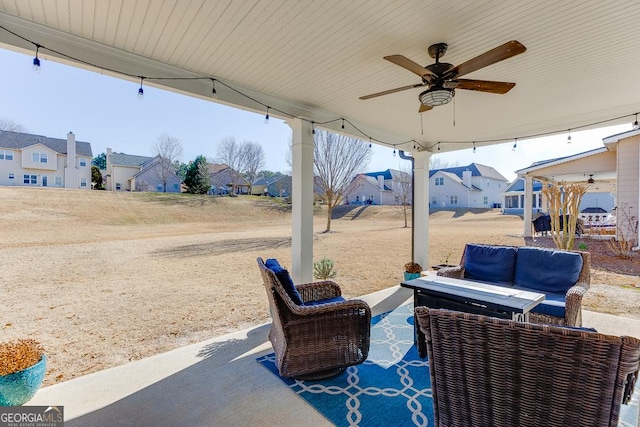 view of patio / terrace with a ceiling fan, a residential view, and an outdoor living space