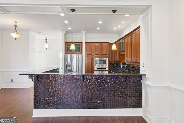 kitchen with glass insert cabinets, tasteful backsplash, appliances with stainless steel finishes, and dark wood-type flooring