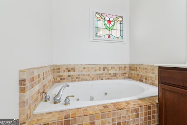 bathroom with a whirlpool tub and vanity