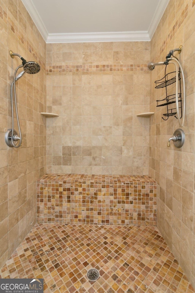 full bathroom with crown molding and tiled shower