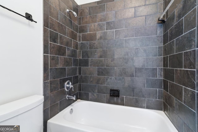 bathroom with washtub / shower combination and toilet