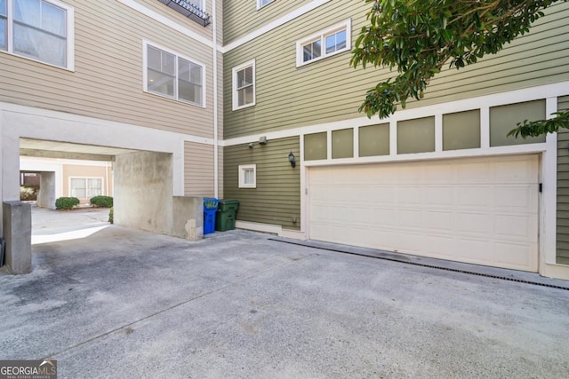 view of property exterior featuring a garage and driveway