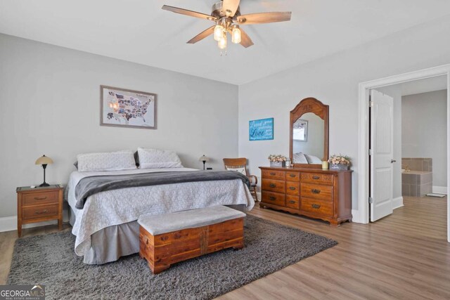 bedroom with a ceiling fan, baseboards, and wood finished floors