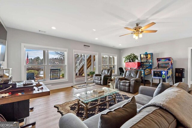 living room with light wood finished floors, recessed lighting, visible vents, ceiling fan, and baseboards