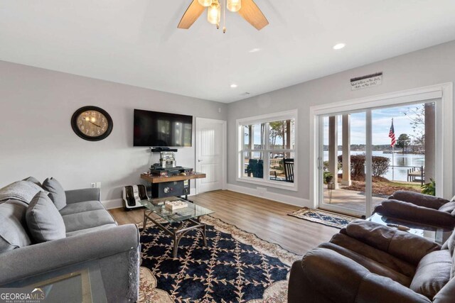 living area with recessed lighting, ceiling fan, baseboards, and wood finished floors