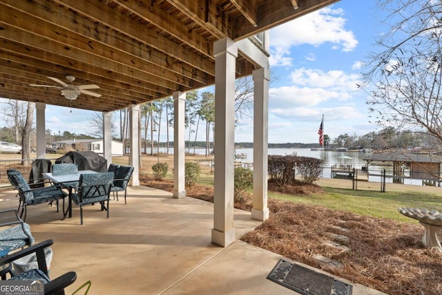 view of patio featuring outdoor dining space, a water view, a grill, and a ceiling fan