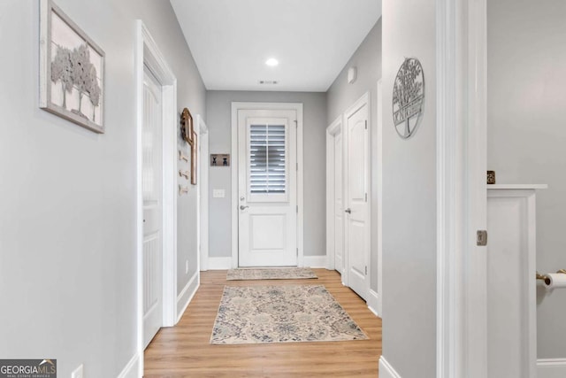 entryway featuring light wood-type flooring and baseboards