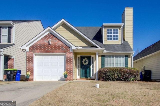 view of front of home with brick siding, a chimney, an attached garage, driveway, and a front lawn