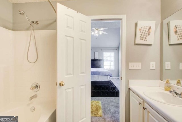 full bathroom featuring tub / shower combination, ceiling fan, vanity, and ensuite bathroom