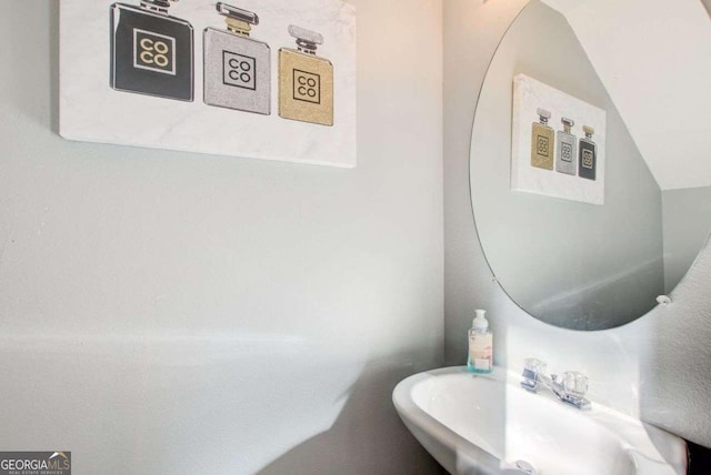 bathroom with lofted ceiling and a sink