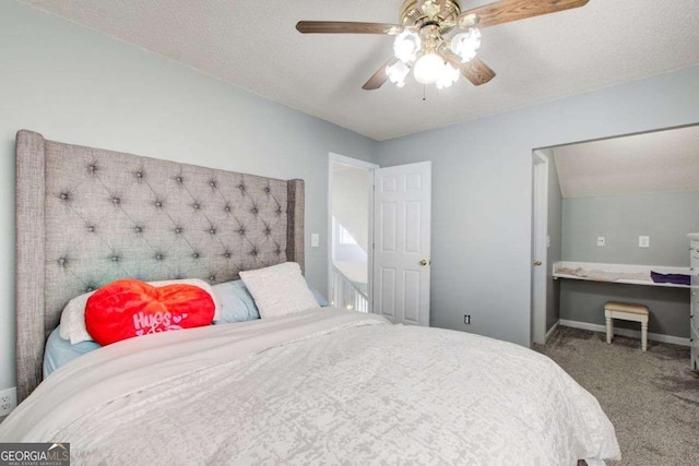 carpeted bedroom featuring a textured ceiling, ceiling fan, and baseboards