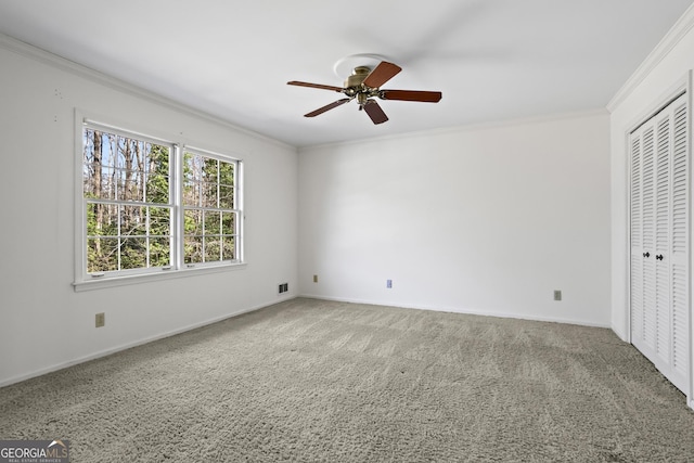 unfurnished bedroom featuring baseboards, carpet, visible vents, and crown molding