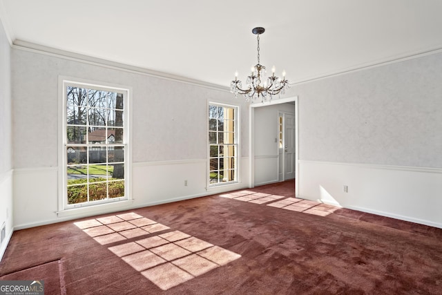 unfurnished dining area featuring carpet floors, a chandelier, and ornamental molding