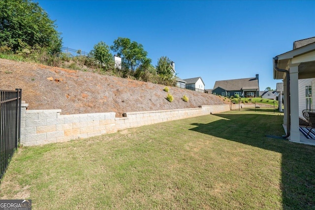 view of yard with a fenced backyard and a residential view