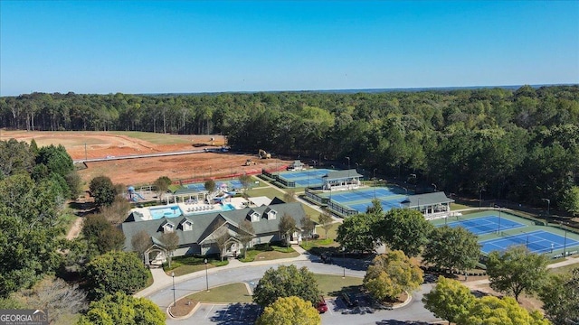 drone / aerial view with a wooded view