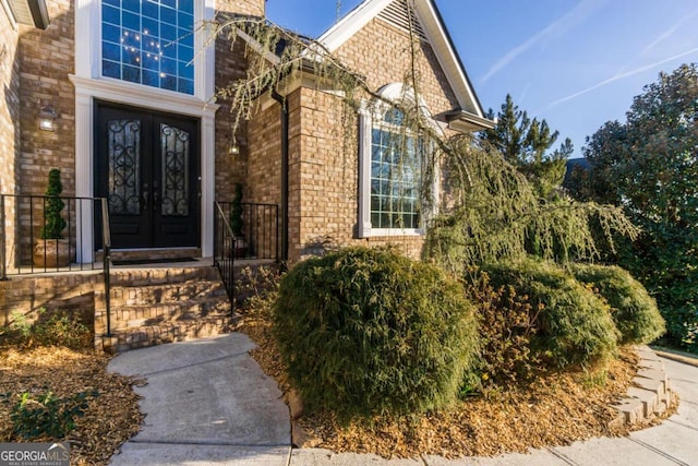 doorway to property with french doors and brick siding