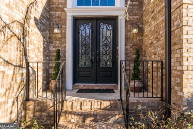 entrance to property featuring brick siding