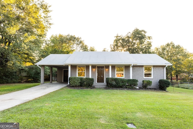 ranch-style house featuring driveway, an attached carport, a front lawn, and brick siding