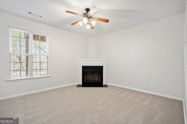 unfurnished living room featuring a fireplace with flush hearth, visible vents, light carpet, and baseboards