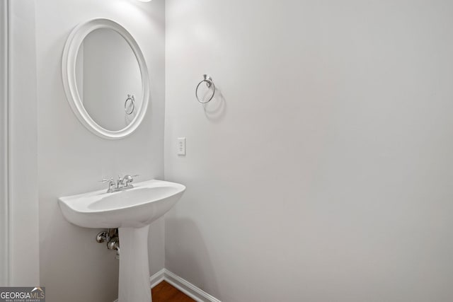 bathroom featuring baseboards and wood finished floors