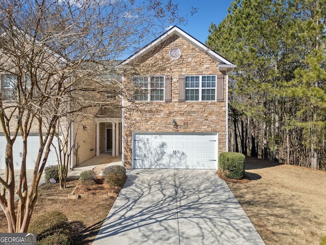 traditional-style home with an attached garage, stone siding, and concrete driveway