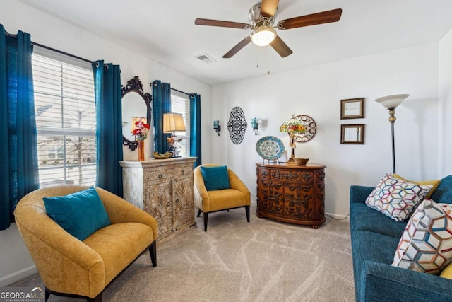 sitting room featuring carpet, visible vents, ceiling fan, and baseboards