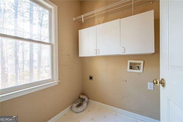 clothes washing area with washer hookup, cabinet space, a wealth of natural light, and hookup for an electric dryer