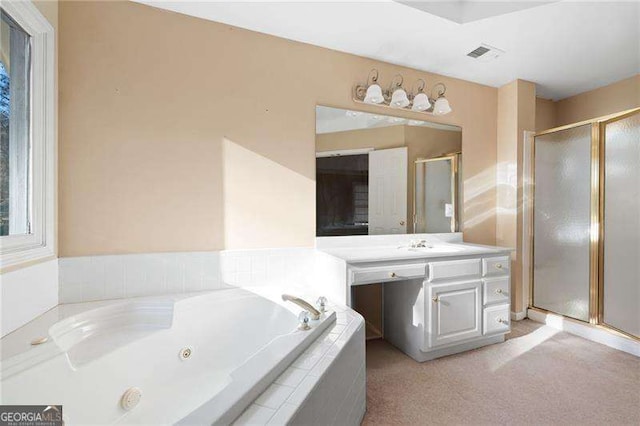 bathroom featuring a stall shower, visible vents, a tub with jets, and vanity