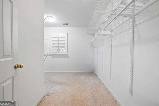 walk in closet with light carpet and visible vents