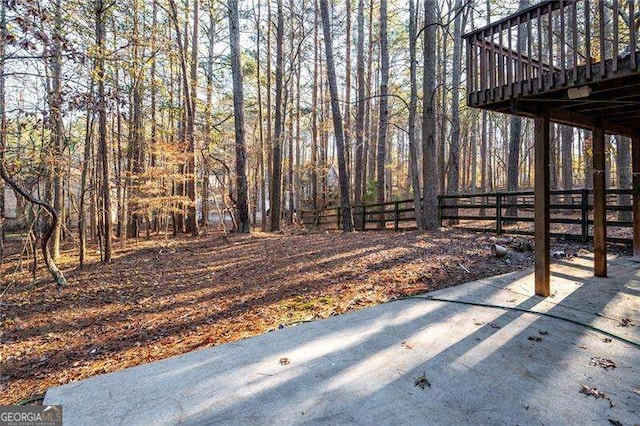 view of yard with fence and a wooden deck