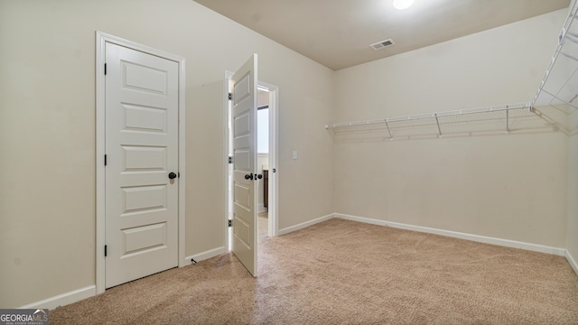 walk in closet with carpet floors and visible vents