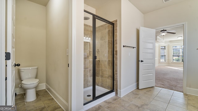 bathroom with toilet, a stall shower, visible vents, and baseboards