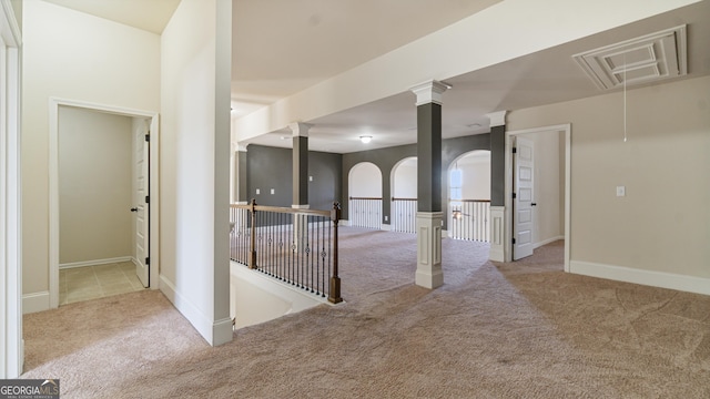 unfurnished room with carpet flooring and attic access