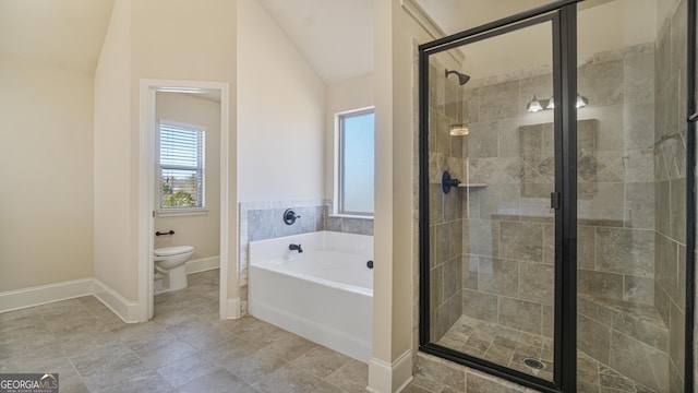 bathroom with toilet, a stall shower, a garden tub, and vaulted ceiling