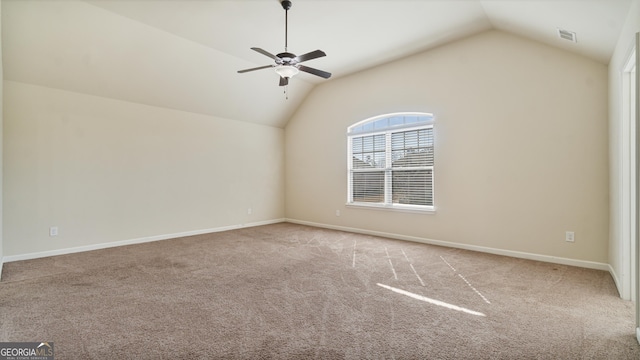 unfurnished room featuring lofted ceiling, a ceiling fan, visible vents, baseboards, and carpet