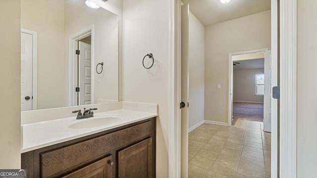 bathroom featuring vanity, baseboards, and tile patterned floors