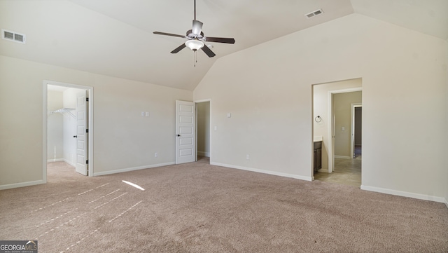 unfurnished bedroom with high vaulted ceiling, visible vents, and light carpet