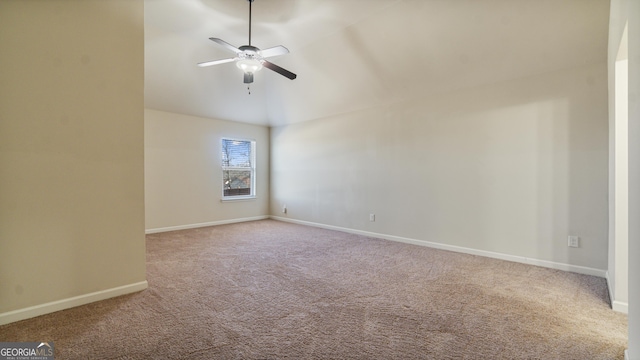 carpeted empty room featuring ceiling fan and baseboards