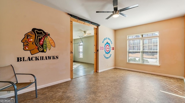 interior space with ceiling fan, tile patterned floors, and baseboards