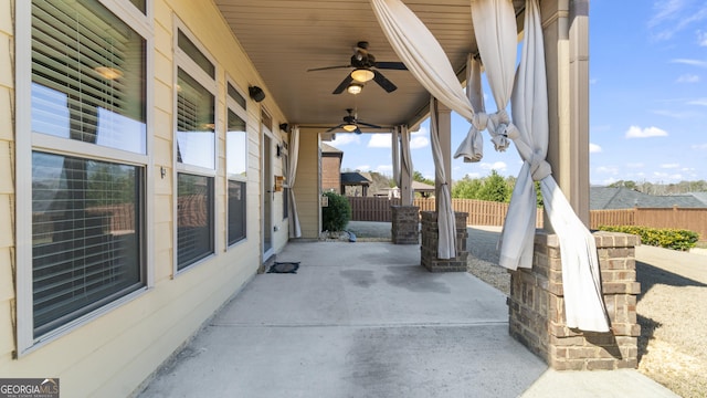 view of patio / terrace with fence and a ceiling fan