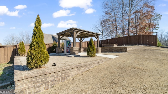 view of yard with a fenced backyard and a gazebo