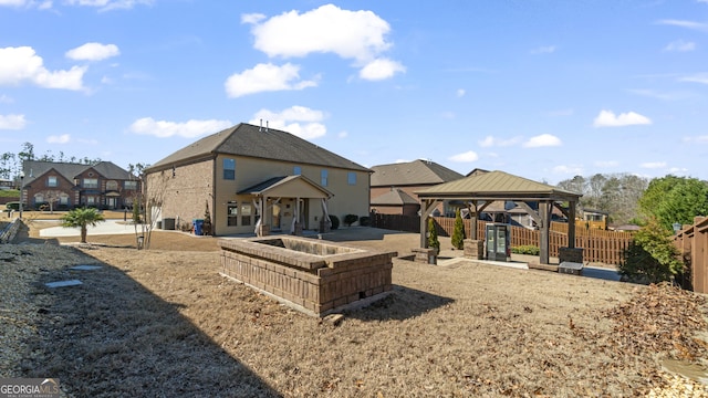 exterior space with a gazebo, a patio area, fence, and a residential view