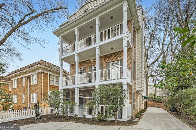397 4th St NE, Atlanta, GA 30308 - view of front of house with a balcony, brick siding, and a porch