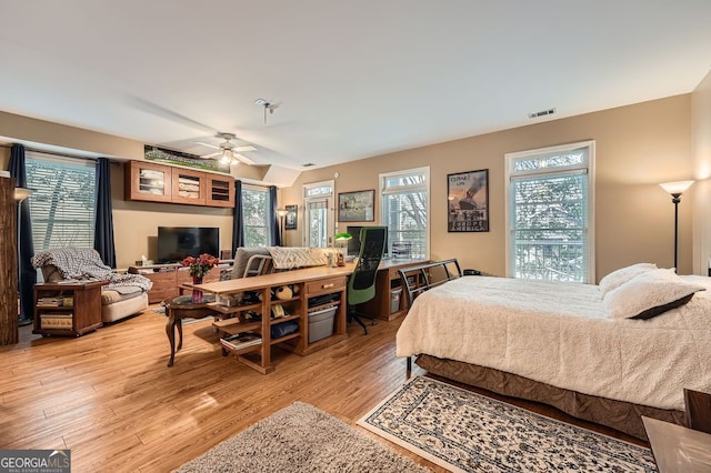 397 4th St NE, Atlanta, GA 30308 - bedroom with light wood finished floors, multiple windows, and ceiling fan
